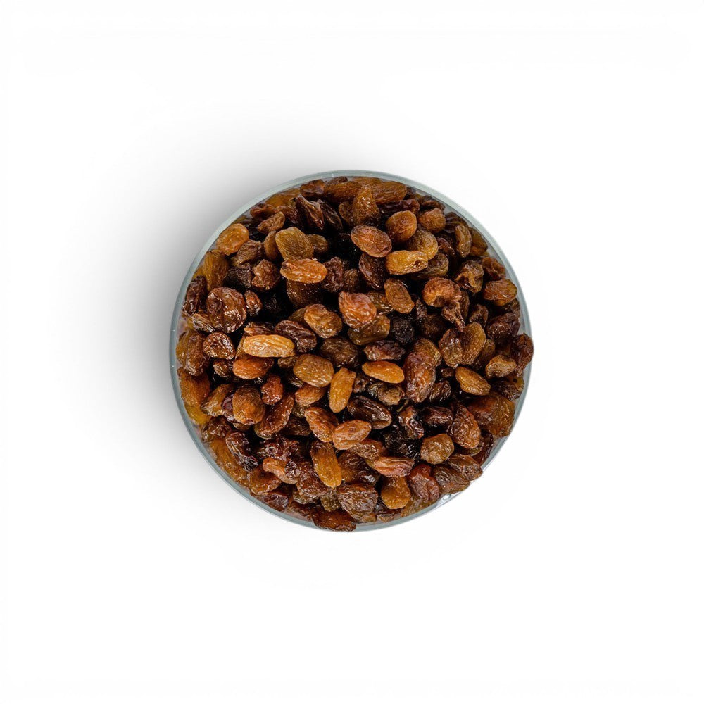 Mahnaz Food bowl filled with sweet dried sultana raisins, a healthy snack rich in fiber and antioxidants.