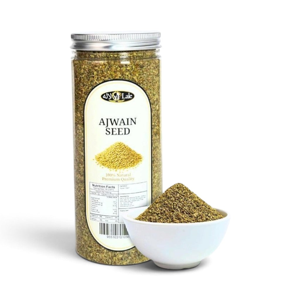 Mahnaz Food Ajwain seeds in a clear plastic jar with a small white bowl of seeds placed in front