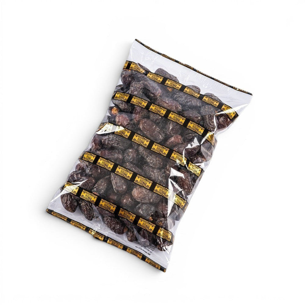 Mahnaz Food Madinah Ajwa dates are dark brown, soft, and wrinkled, packaged in a clear bag with a branded gold and black band.