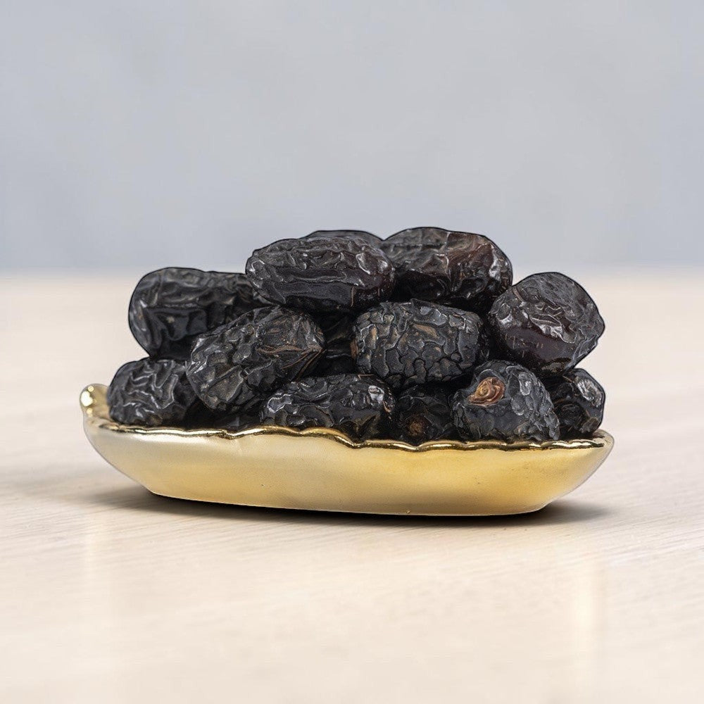 Mahnaz Food Madinah Ajwa dates are dark brown to black, soft, and wrinkled. Available in large to jumbo sizes.