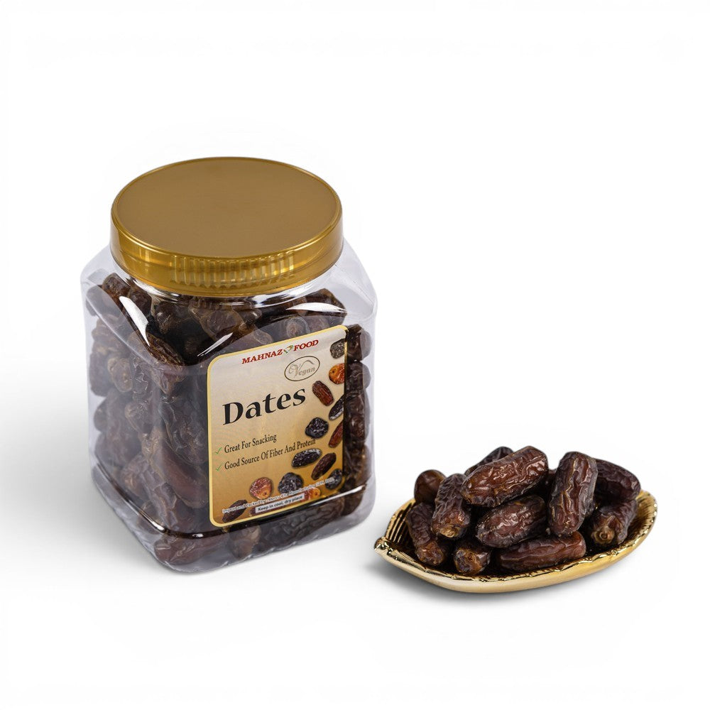 Mahnaz Food Mariami Dates in a clear jar and a golden dish. Dark brown, chewy dates, perfect for snacking.