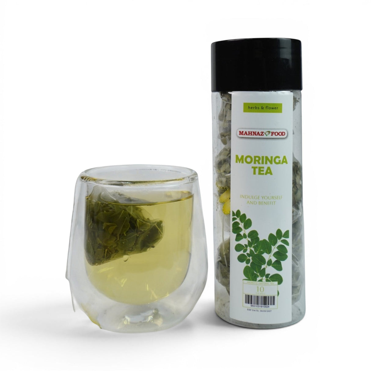 Mahnaz Food Moringa Herbal Tea Bags in a clear glass with a tea bag steeping, next to a clear container of tea bags.