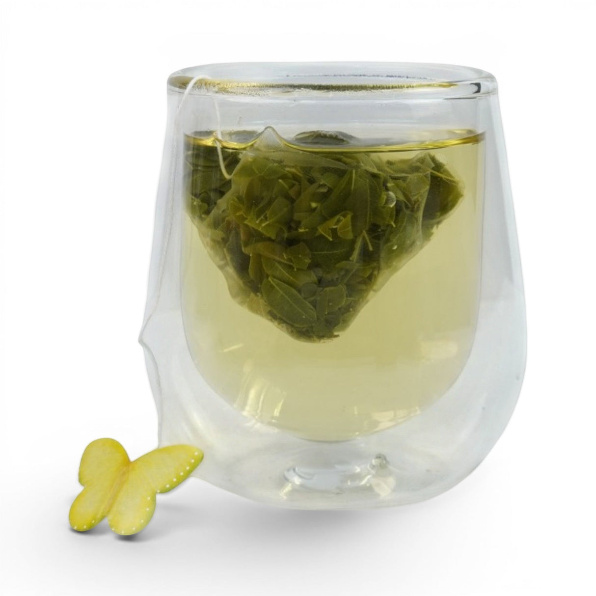 Mahnaz Food Moringa Herbal Tea Bags steeping in a clear glass cup with a yellow butterfly charm.