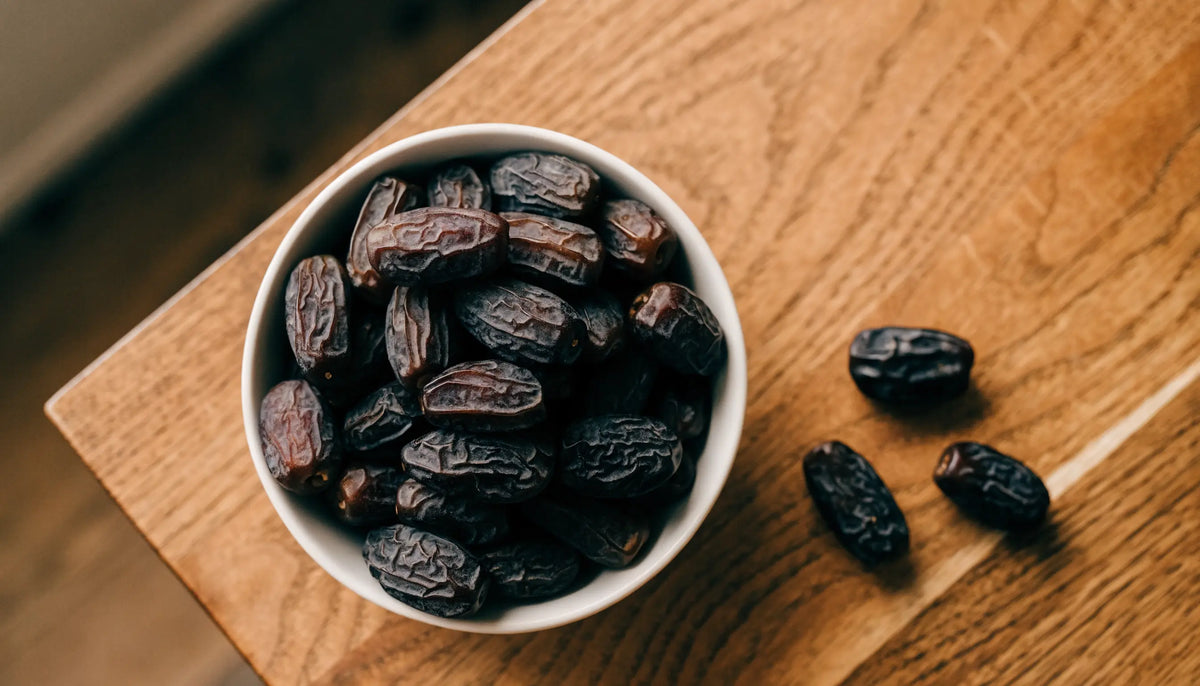 Bowl of dark premium Ajwa dates from Madinah with soft wrinkled skin