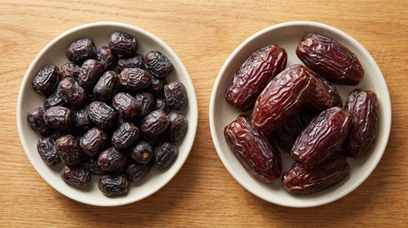 Small dark Ajwa dates beside large reddish-brown Medjool dates in two dishes