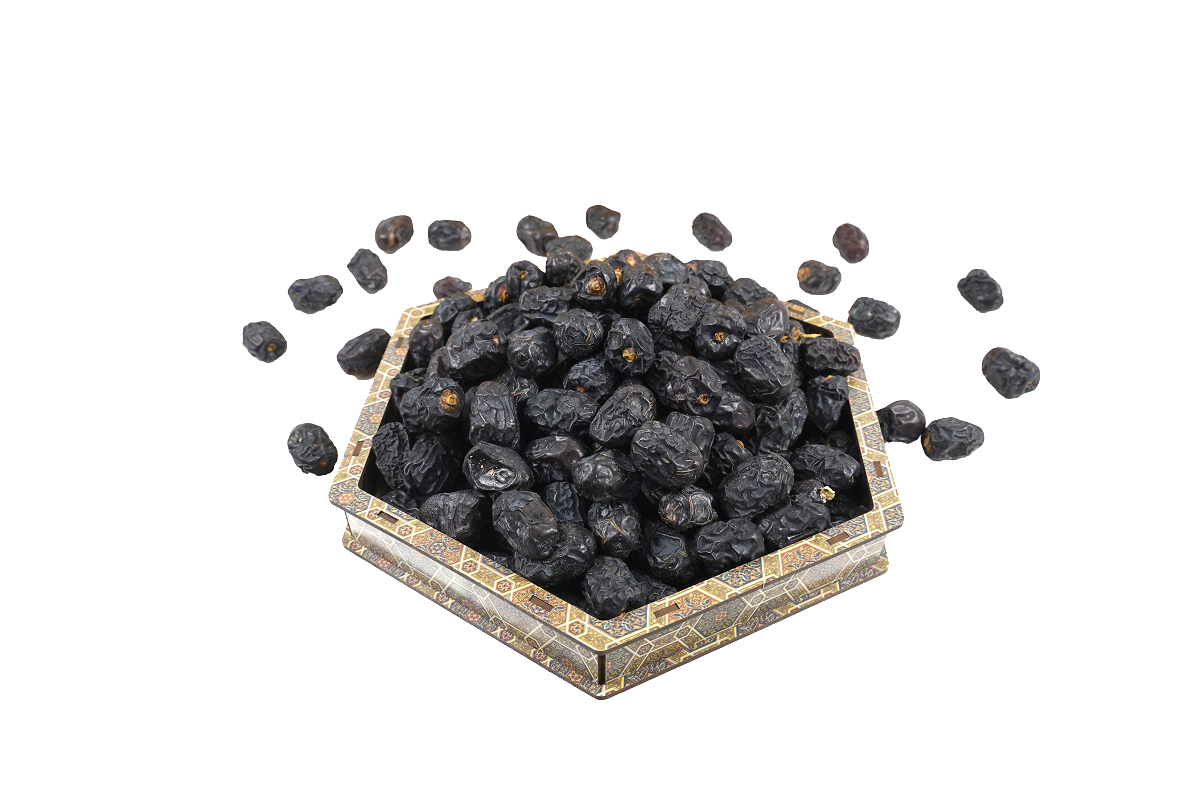 Mahnaz Food premium Ajwa AA dates in a decorative hexagonal tray, featuring deep black wrinkled skin.