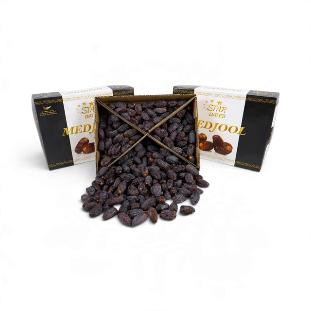 Mahnaz Food Qamar Palestinian jumbo Medjoul dates in a large 5kg box with dark brown, succulent fruit spilling out.