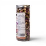 Mahnaz Food Memory Tea loose leaf blend of rose petals, saffron, and cardamom in a clear jar. Herbal remedies.