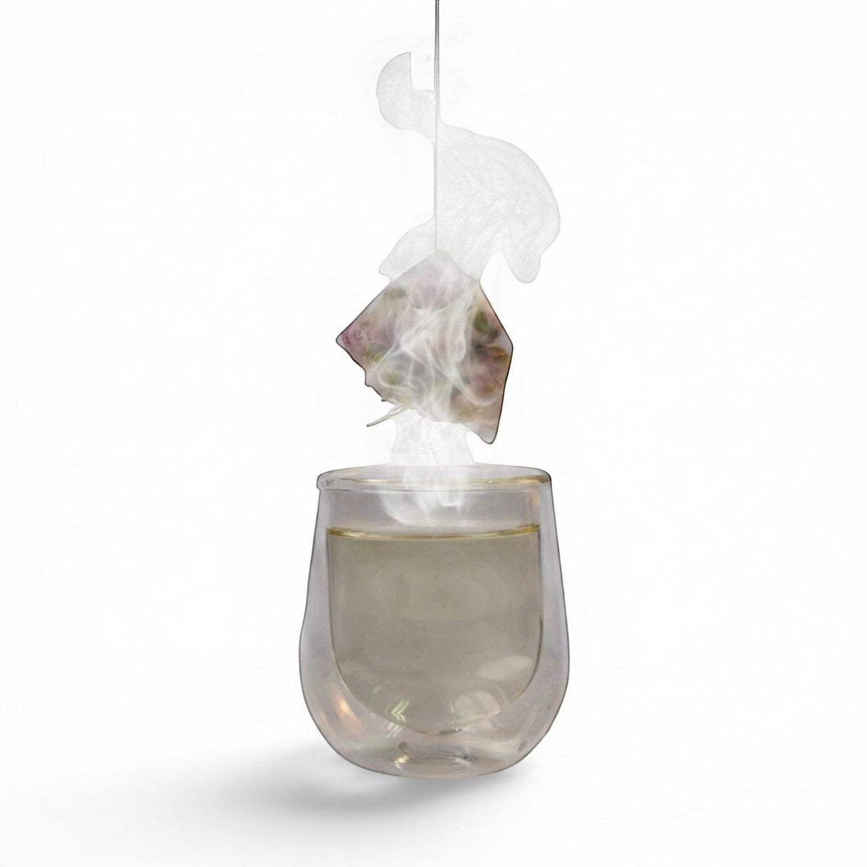Mahnaz Food Rose Tea sachet steeping in a clear glass of hot tea, releasing steam.