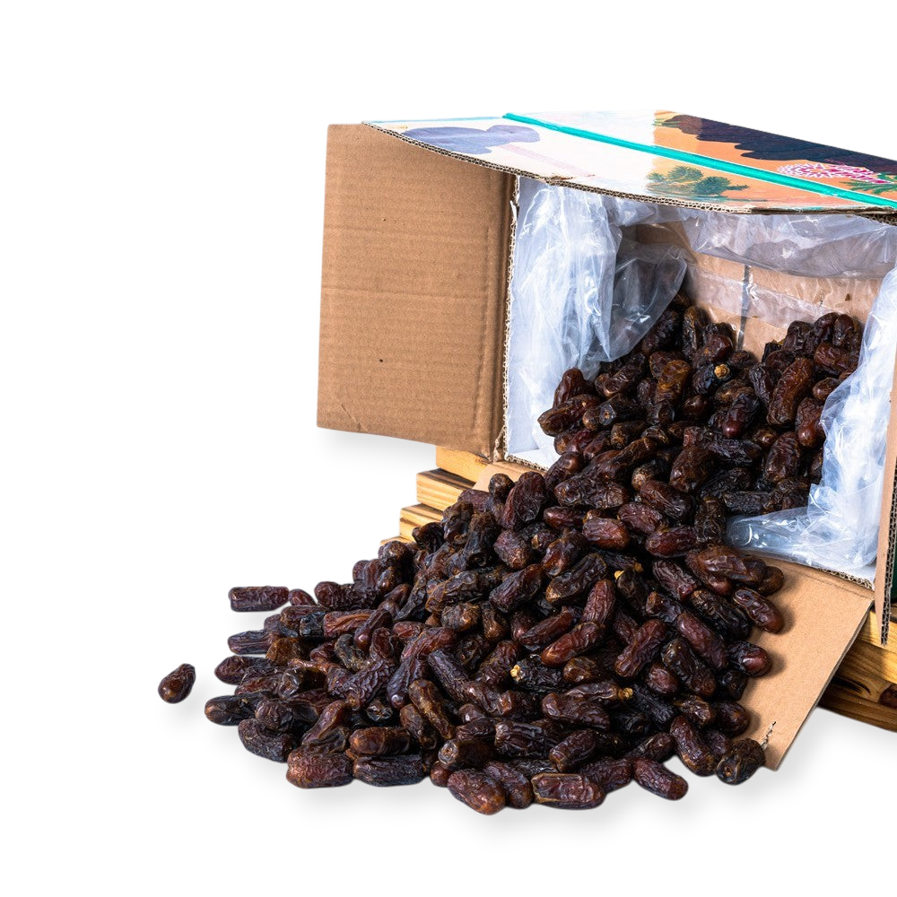 Mahnaz Food premium Mariami dates spilling from a wholesale cardboard box on a white background