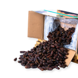Mahnaz Food premium Mariami dates spilling from a wholesale cardboard box on a white background