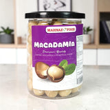 Mahnaz Food premium quality macadamia nuts in a clear plastic jar with a purple label and black lid.