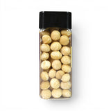 Mahnaz Food premium macadamia nuts in a clear rectangular plastic container with a black lid, top-down view.