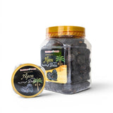 Mahnaz Food Madinah Ajwa organic dates in a clear plastic jar and a smaller round container. Dark brown, wrinkled dates.