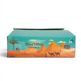 Mahnaz Food Ajwa Village Grade A dates packaging with desert scene, pyramids, camels, and palm tree.