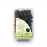 Mahnaz Food Madinah Ajwa dates, dark brown, soft, wrinkled, premium organic dates in a clear plastic container.