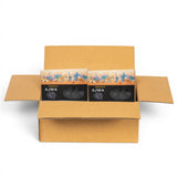 Mahnaz Food premium Ajwa dates in packaging inside a cardboard box, featuring a desert scene with camels.