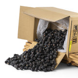 Mahnaz Food premium Ajwa dates spilling from a cardboard box, dark brown and soft texture.