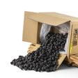 Mahnaz Food premium Ajwa dates spilling from a cardboard box, naturally sweet and soft.