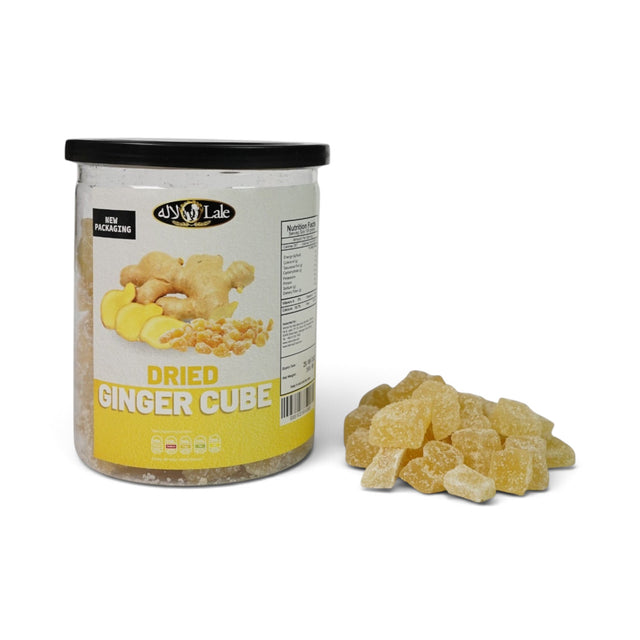Mahnaz Food dried ginger cubes in a clear plastic jar with a pile of sugar-coated ginger pieces on the side