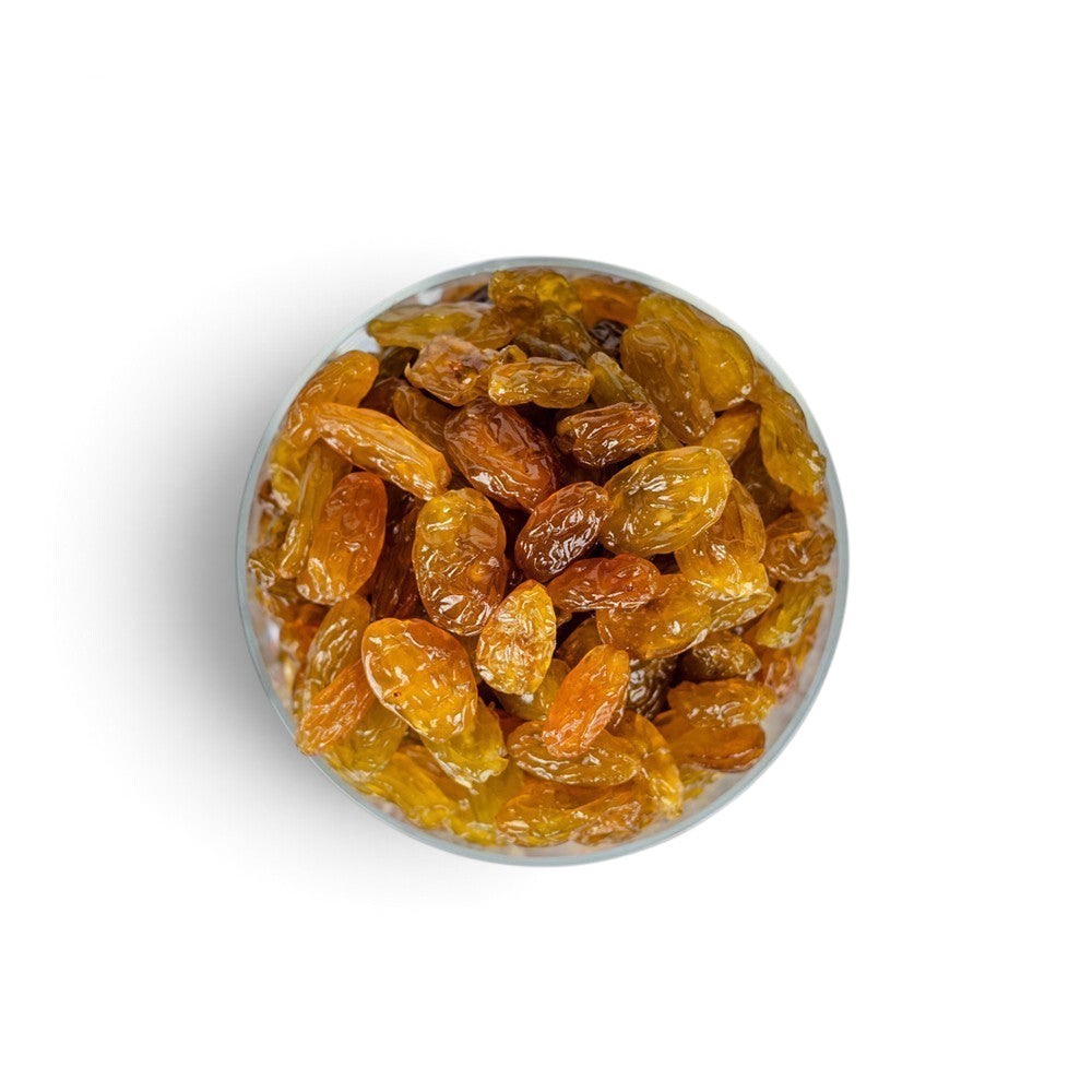 Mahnaz Food golden jumbo raisins in a glass bowl, a healthy dried fruit snack rich in fiber and natural energy.