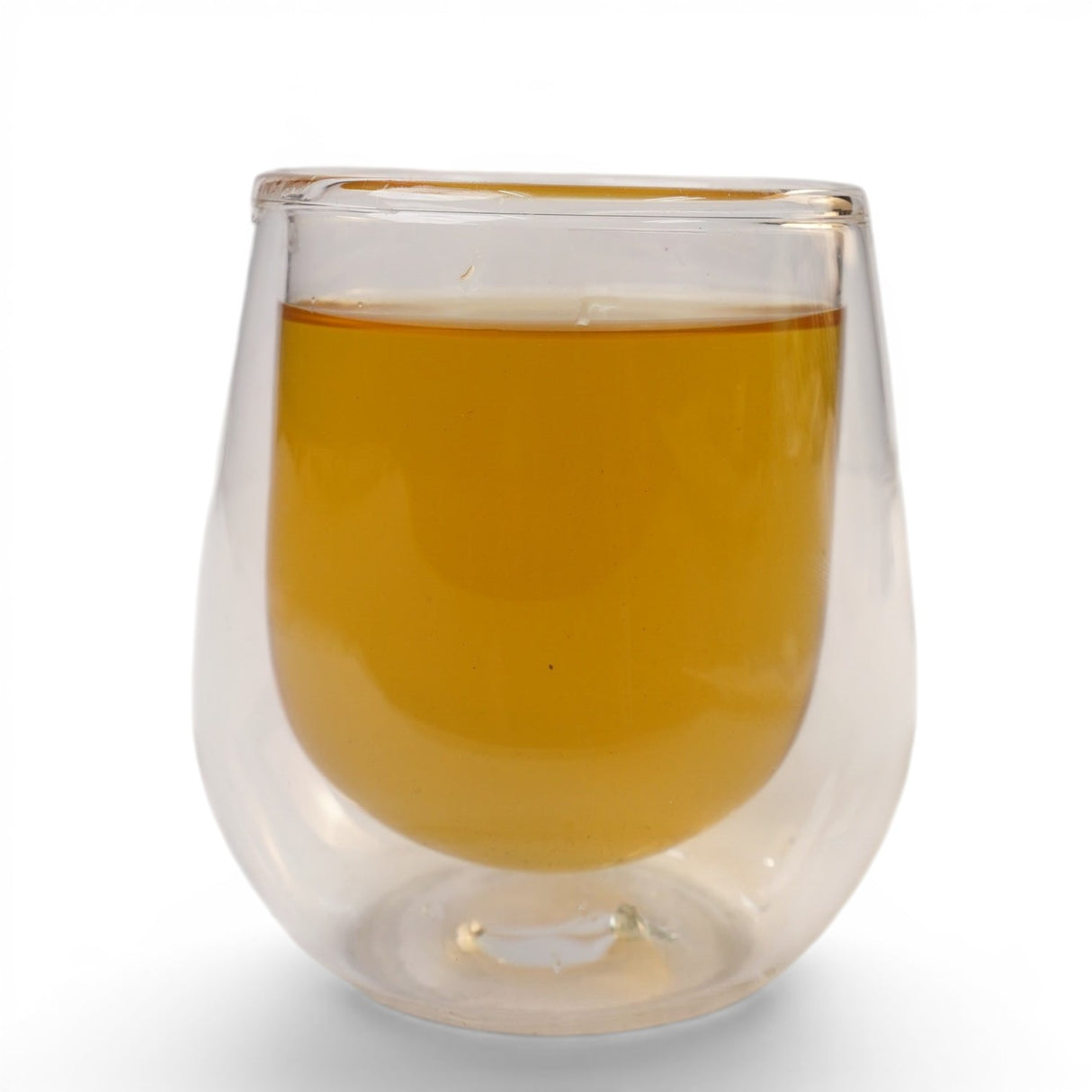 Mahnaz Food herbal senna leaf tea in a clear double-walled glass, golden amber color, caffeine-free.