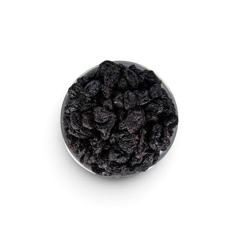 Mahnaz Food jumbo black raisins in a glass bowl, a healthy dried fruit snack rich in fiber and antioxidants.