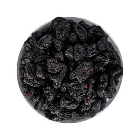 Mahnaz Food jumbo black raisins in a glass bowl, a healthy dried fruit snack rich in fiber and antioxidants.