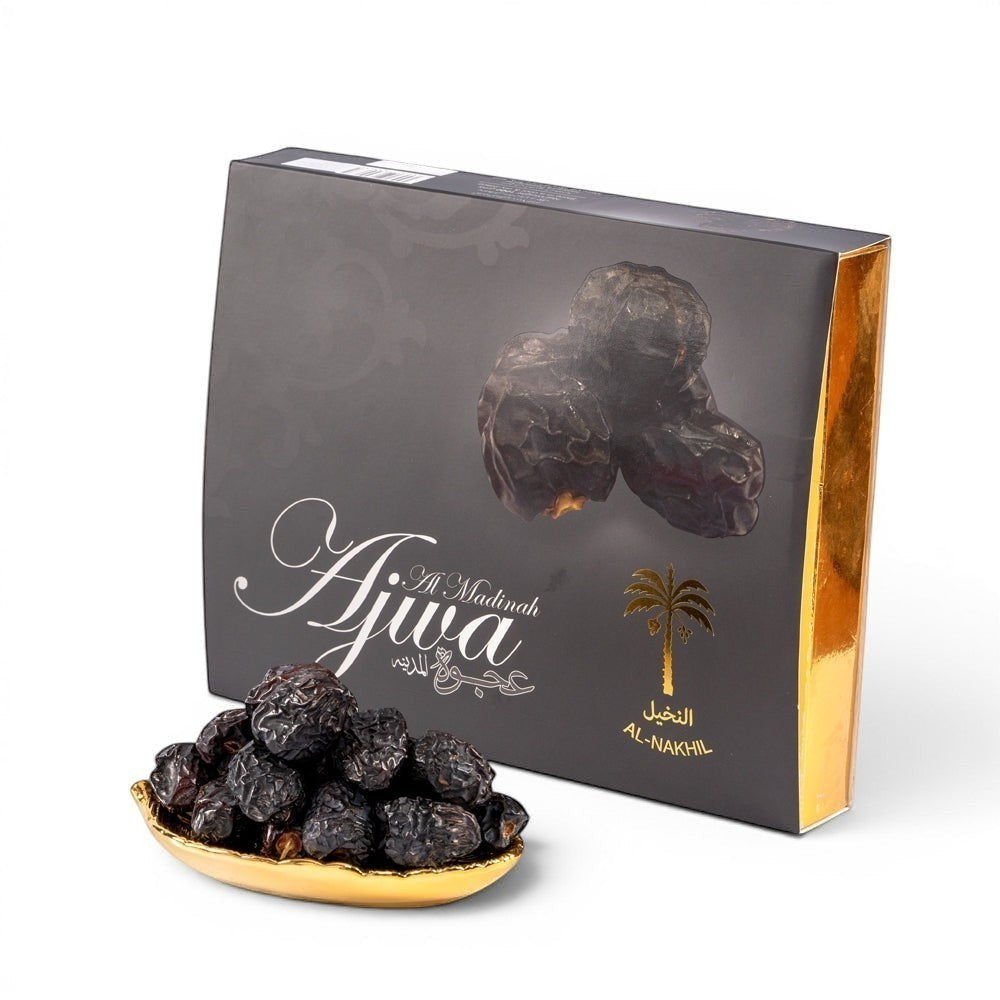 Mahnaz Food Madinah Ajwa dates, dark brown to black with wrinkles, soft dry fruit in premium packaging.