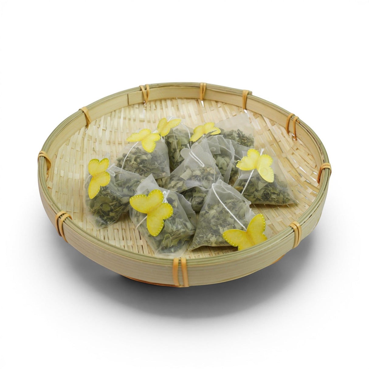 Mahnaz Food Moringa Herbal Tea Bags in a bamboo basket, featuring pyramid tea bags with yellow butterfly accents.
