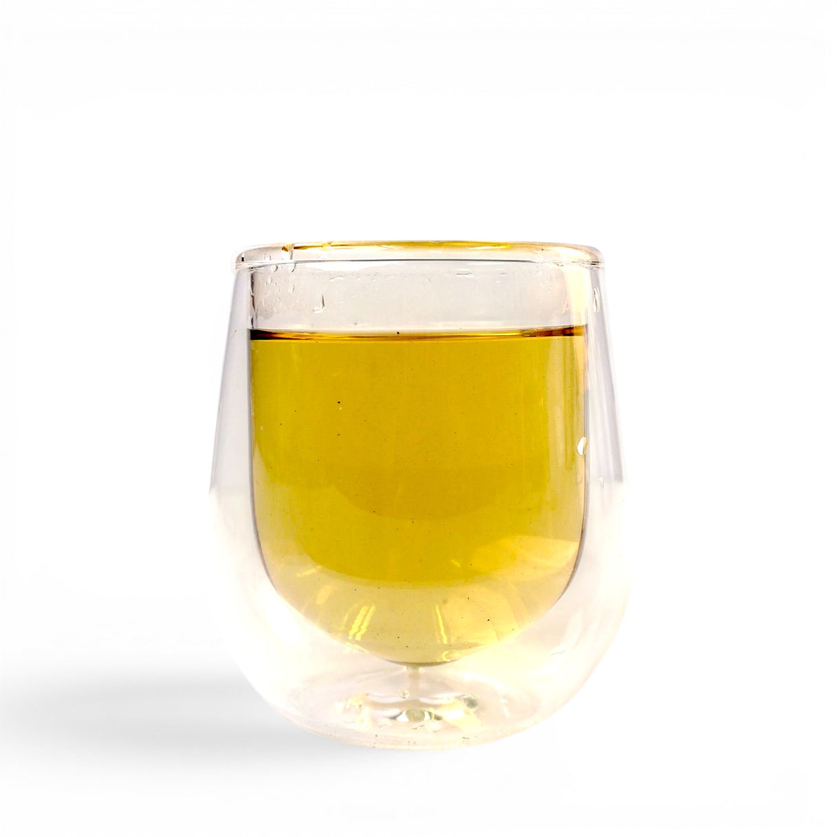 Mahnaz Food Nettle Tea, a golden herbal infusion in a clear double-walled glass, perfect for daily wellness.
