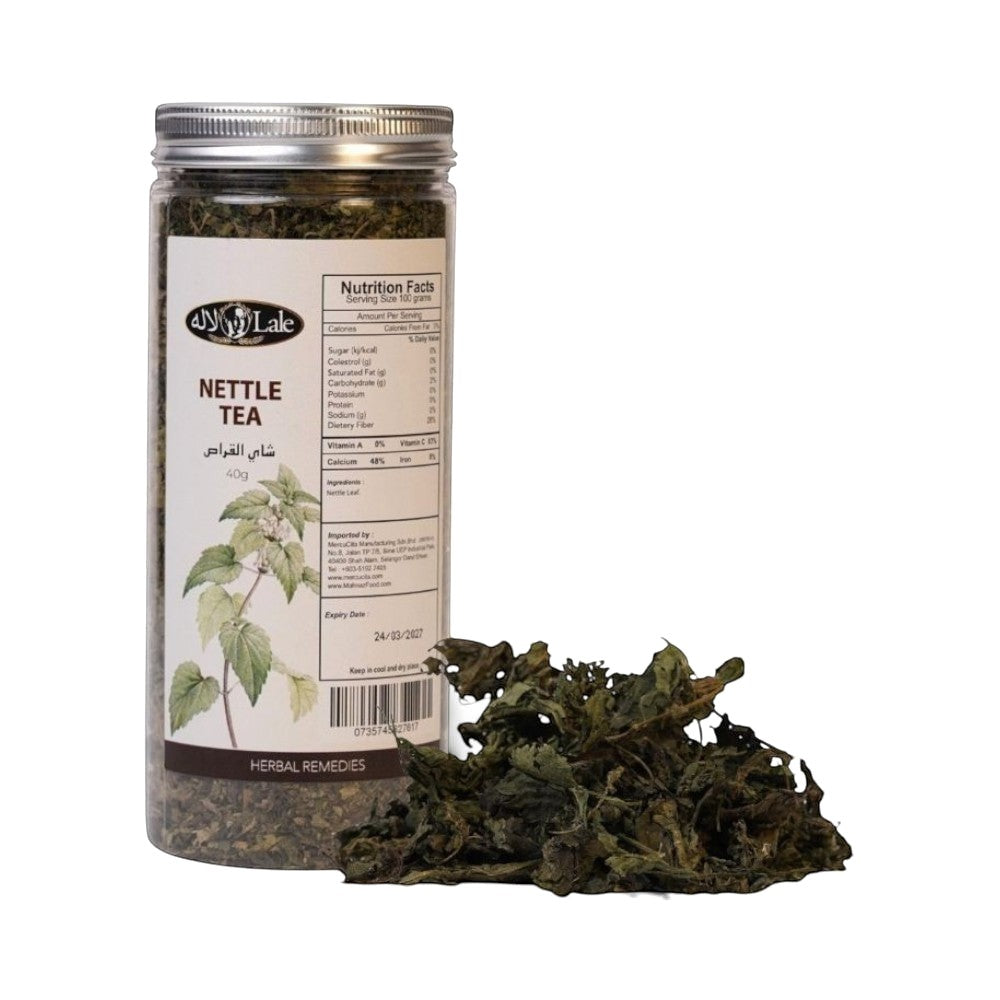 Mahnaz Food Nettle Tea loose leaf in a clear jar with nutrition facts and expiry date. Dried nettle leaves spill out.