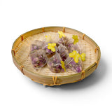Mahnaz Food rose tea bags filled with dried rose petals, presented in a bamboo basket with yellow butterfly accents.