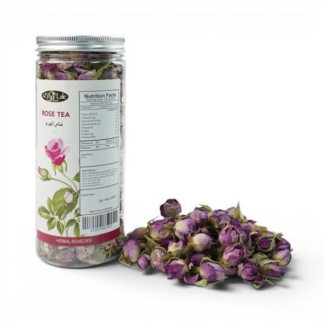 Mahnaz Food Rose Tea loose dried rose buds in a clear jar and scattered on a white surface. Herbal remedies.