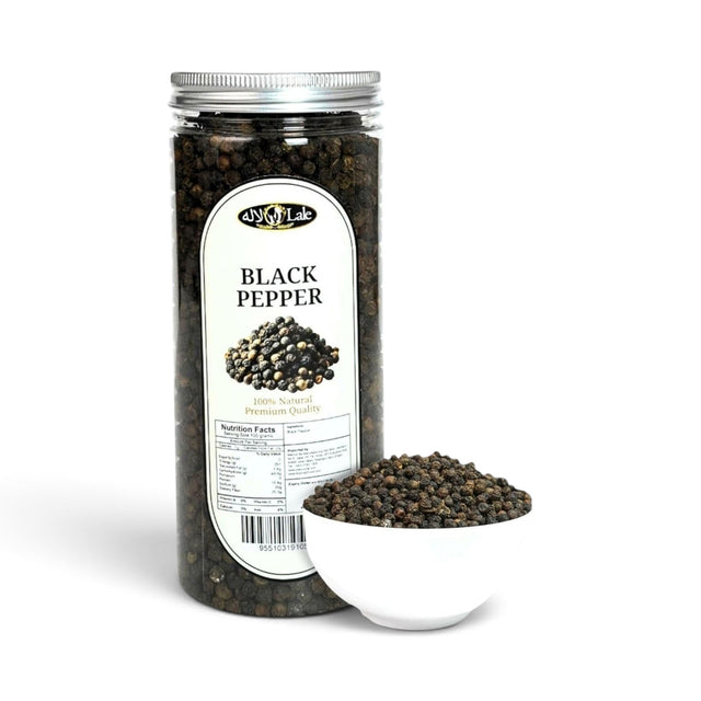 Mahnaz Food premium whole black peppercorns in a clear plastic jar next to a small white bowl filled with peppercorns