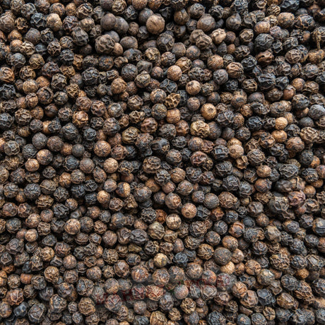 Mahnaz Food premium whole black peppercorns with a rich, dark texture, perfect for seasoning and fresh grinding.
